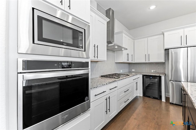 4201 Arques Ave, Round Rock, TX 78681 - kitchen featuring beverage cooler, stainless steel appliances, wall chimney range hood, white cabinets, and dark wood-type flooring