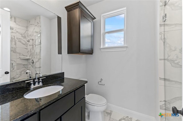 4201 Arques Ave, Round Rock, TX 78681 - full bathroom featuring marble look tile flooring, a marble finish shower, baseboards, vanity, and toilet