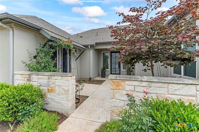 4201 Arques Ave, Round Rock, TX 78681 - doorway to property featuring stucco siding, a shingled roof, and a patio