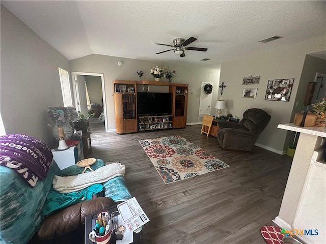 living room featuring visible vents, ceiling fan, baseboards, vaulted ceiling, and wood finished floors