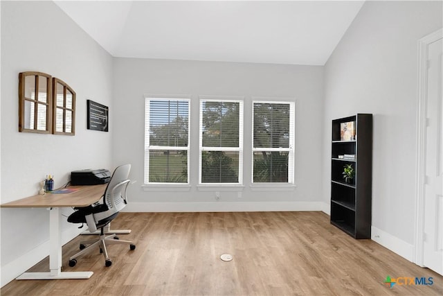 office space featuring lofted ceiling and light hardwood / wood-style floors