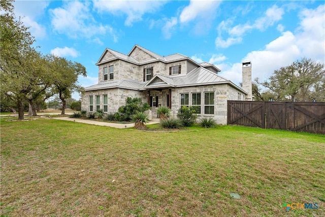 rear view of property featuring a lawn