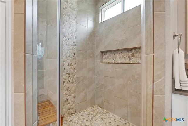 bathroom with a tile shower