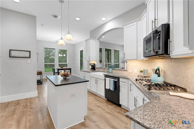 kitchen with dishwasher, white cabinetry, hanging light fixtures, a kitchen island, and stainless steel gas stovetop