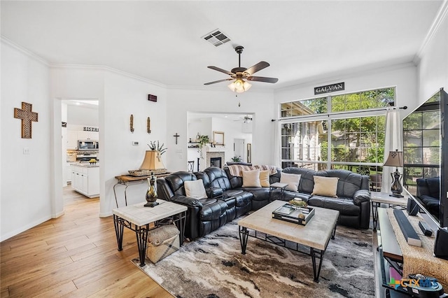 4010 Halfway Cv, Round Rock, TX 78681 - living area with ornamental molding, light wood-style flooring, visible vents, and ceiling fan