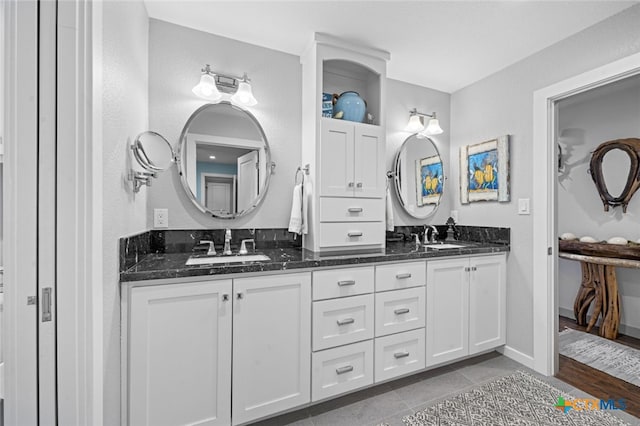 bathroom featuring double vanity, tile patterned flooring, and a sink