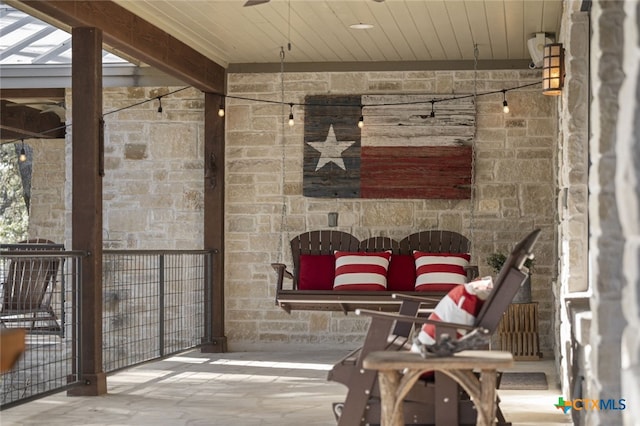 view of patio / terrace featuring an outdoor stone fireplace