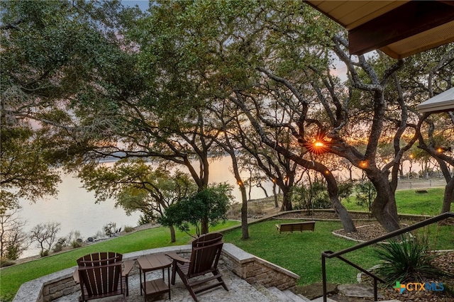 view of property's community with a patio and a lawn