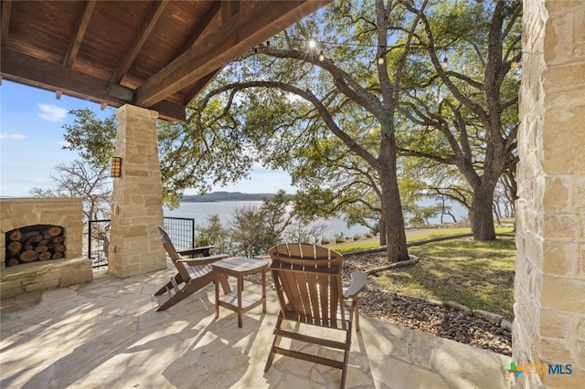 view of patio / terrace with an outdoor stone fireplace