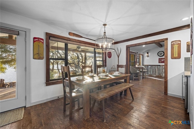 dining room featuring lofted ceiling, beverage cooler, dark wood-type flooring, and baseboards