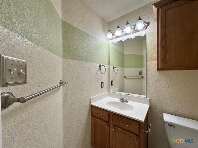 4609 Golden Gate Dr, Killeen, TX 76549 - bathroom featuring a textured wall and vanity