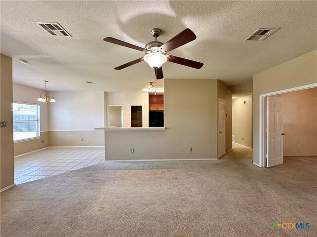 4609 Golden Gate Dr, Killeen, TX 76549 - tiled empty room with carpet floors, a chandelier, a ceiling fan, and a textured ceiling