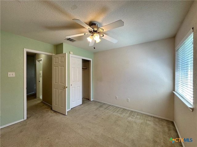 4609 Golden Gate Dr, Killeen, TX 76549 - unfurnished bedroom with light colored carpet, a closet, a textured ceiling, and ceiling fan