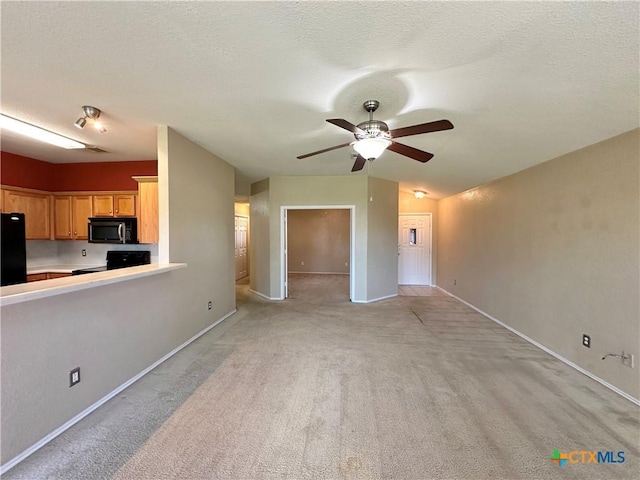 4609 Golden Gate Dr, Killeen, TX 76549 - unfurnished living room with a ceiling fan, light carpet, and a textured ceiling