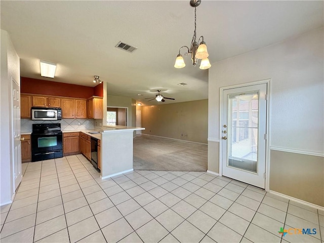 4609 Golden Gate Dr, Killeen, TX 76549 - kitchen featuring black appliances, open floor plan, a peninsula, a chandelier, and light countertops