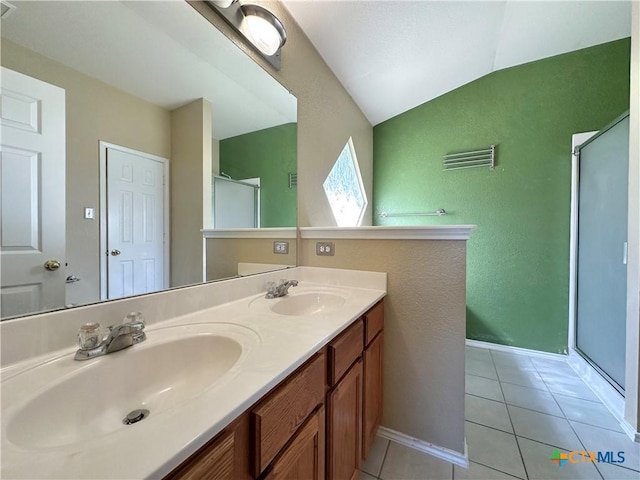 4609 Golden Gate Dr, Killeen, TX 76549 - bathroom featuring a shower stall, tile patterned floors, double vanity, lofted ceiling, and a textured wall