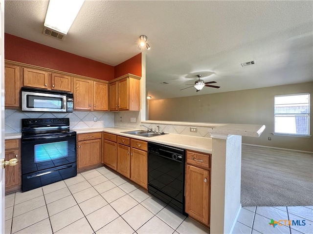 4609 Golden Gate Dr, Killeen, TX 76549 - kitchen featuring black appliances, a peninsula, open floor plan, light tile patterned flooring, and a textured ceiling