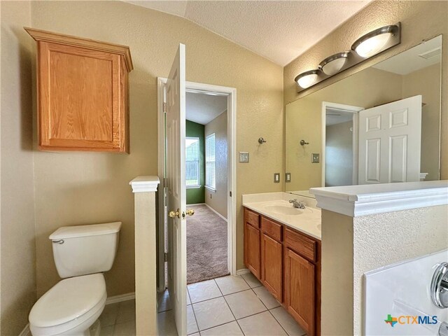 4609 Golden Gate Dr, Killeen, TX 76549 - bathroom featuring lofted ceiling, vanity, tile patterned flooring, and a textured ceiling