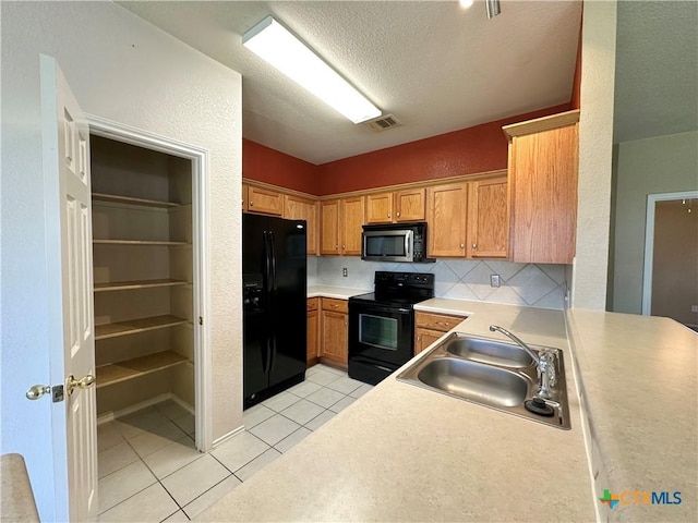 4609 Golden Gate Dr, Killeen, TX 76549 - kitchen with black appliances, light tile patterned floors, a textured ceiling, light countertops, and lofted ceiling