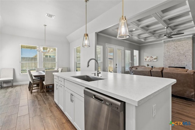 kitchen with visible vents, dishwasher, wood finished floors, a sink, and ceiling fan with notable chandelier