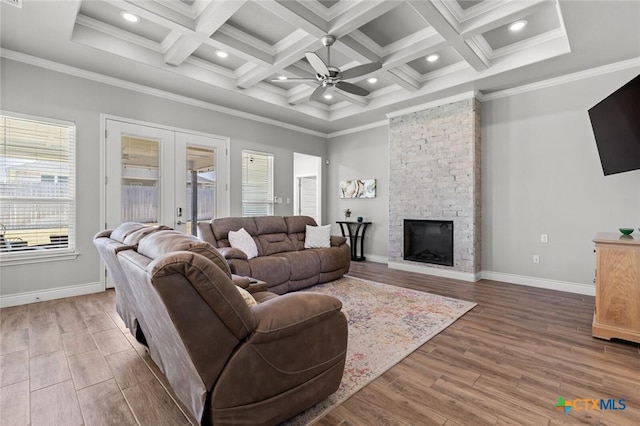 living room featuring french doors, a ceiling fan, crown molding, and wood finished floors