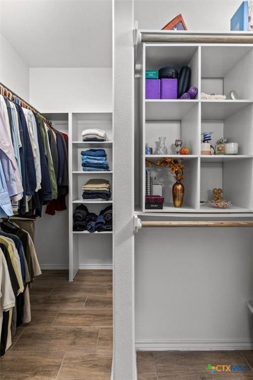walk in closet featuring wood finish floors