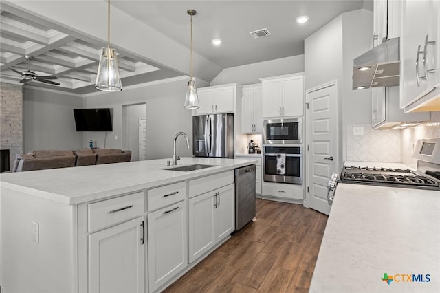 kitchen with coffered ceiling, stainless steel appliances, under cabinet range hood, a sink, and visible vents