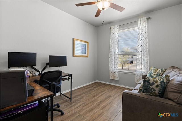 office area featuring baseboards, wood finished floors, and a ceiling fan