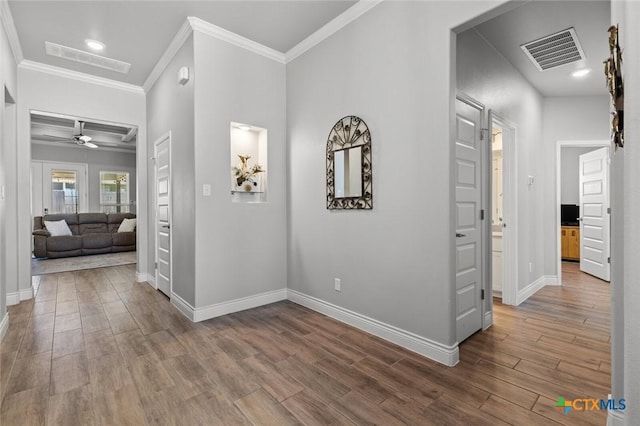 hallway featuring visible vents and wood finished floors