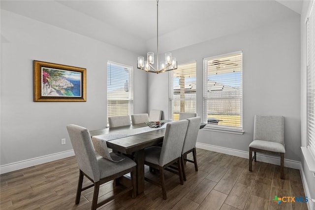 dining room with dark wood-style floors, baseboards, and an inviting chandelier