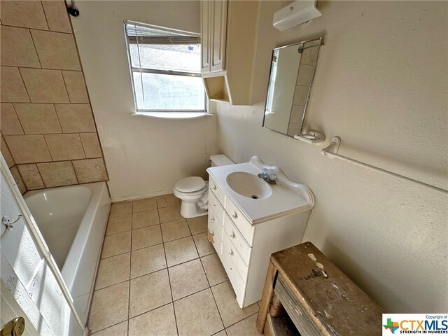 bathroom with vanity, tile patterned flooring, and toilet