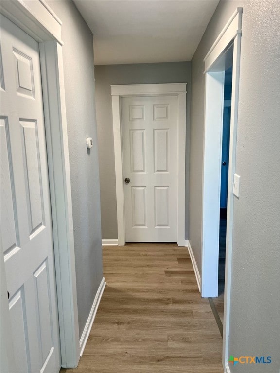 corridor featuring light hardwood / wood-style floors