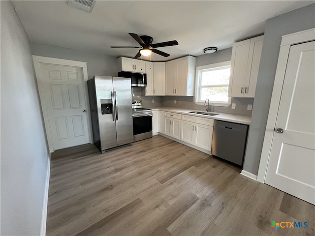 kitchen featuring white cabinetry, sink, and appliances with stainless steel finishes