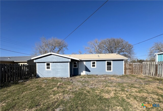 back of house featuring a lawn