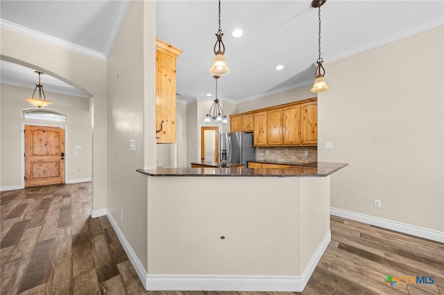 1117 Myrtle Dr, Copperas Cove, TX 76522 - kitchen featuring stainless steel fridge with ice dispenser, dark wood finished floors, decorative backsplash, crown molding, and hanging light fixtures