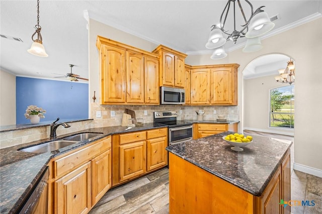 1117 Myrtle Dr, Copperas Cove, TX 76522 - kitchen with stainless steel appliances, a chandelier, ornamental molding, tasteful backsplash, and dark stone countertops