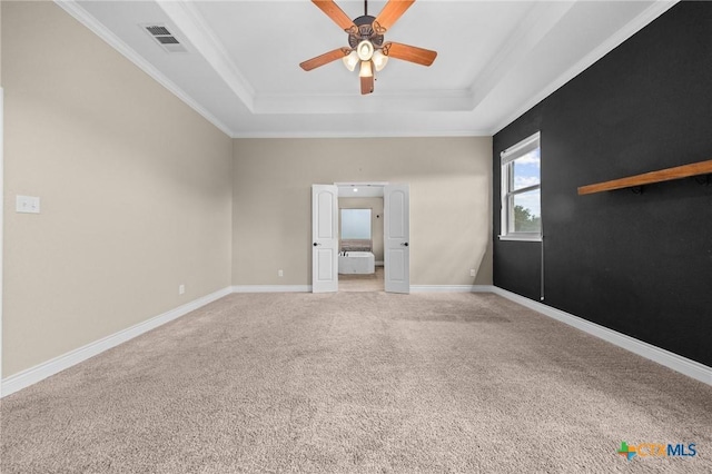 1117 Myrtle Dr, Copperas Cove, TX 76522 - empty room featuring a raised ceiling, ceiling fan, light carpet, and ornamental molding