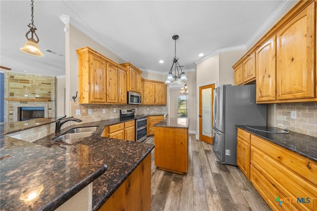 1117 Myrtle Dr, Copperas Cove, TX 76522 - kitchen featuring appliances with stainless steel finishes, crown molding, dark wood-style flooring, tasteful backsplash, and dark stone countertops