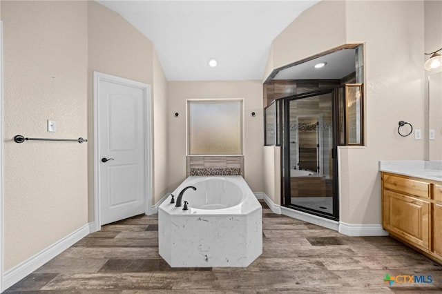1117 Myrtle Dr, Copperas Cove, TX 76522 - bathroom with vanity, a stall shower, a garden tub, and wood finished floors
