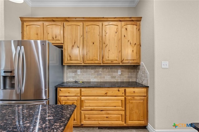 1117 Myrtle Dr, Copperas Cove, TX 76522 - kitchen with stainless steel fridge with ice dispenser, backsplash, dark stone counters, and crown molding