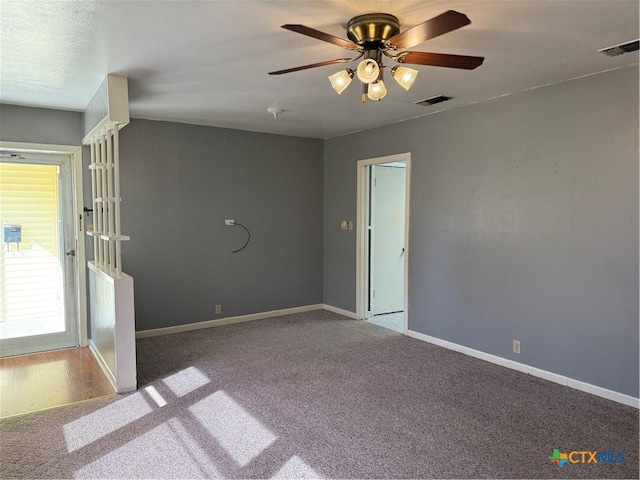 empty room featuring ceiling fan and light colored carpet