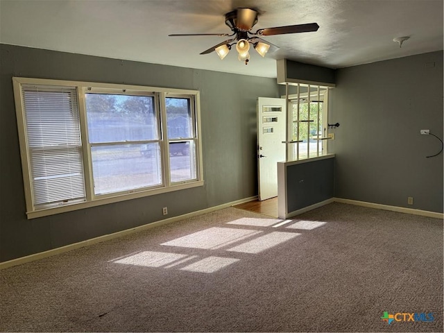 carpeted empty room featuring ceiling fan