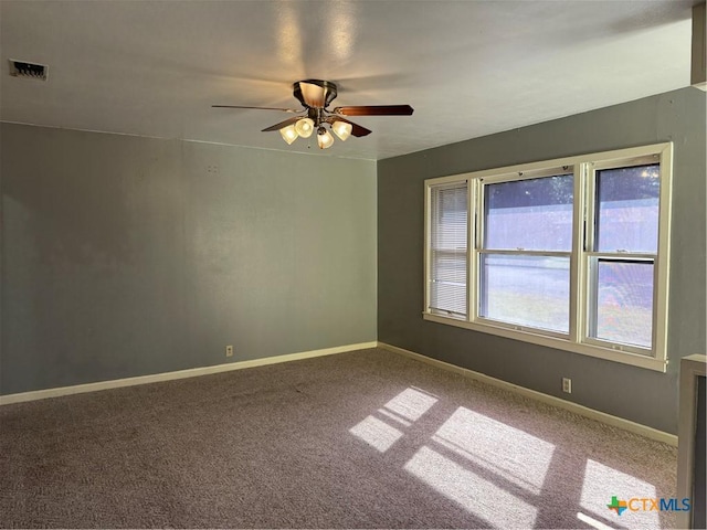 unfurnished room with ceiling fan and carpet flooring