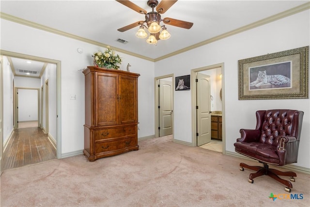 living area featuring ceiling fan, ornamental molding, and light carpet