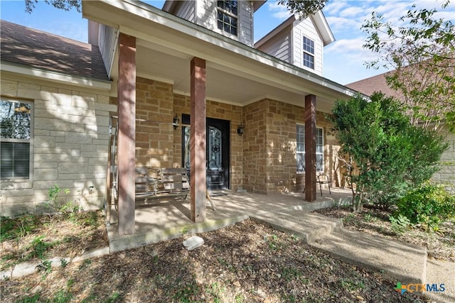 view of exterior entry with covered porch