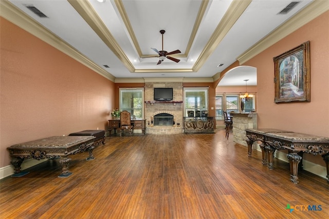 living room featuring hardwood / wood-style floors, ceiling fan with notable chandelier, and a wealth of natural light