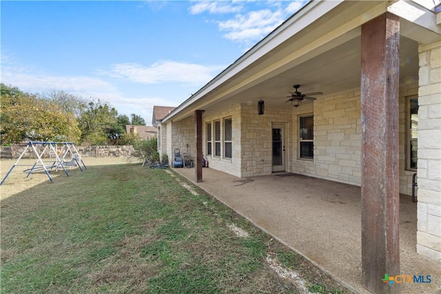 view of yard with ceiling fan, a patio area, and a playground