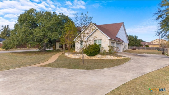 view of front of home featuring a garage and a front lawn