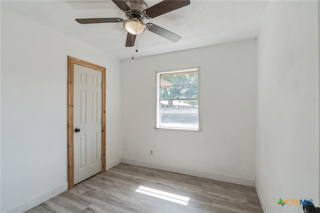 empty room with light hardwood / wood-style floors and ceiling fan