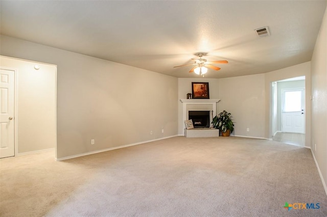 3903 Kevin Shaw Dr, Killeen, TX 76549 - unfurnished living room featuring a ceiling fan, carpet, and a fireplace with raised hearth